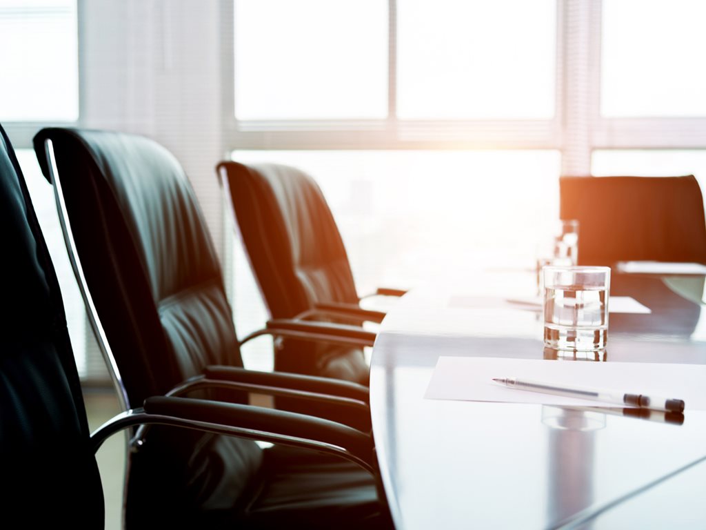 White paper and pen in a modern board room.