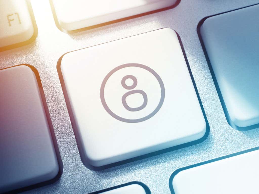 Close up of key board, focused on one key - an icon of a person.