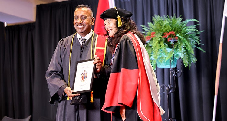 Man receiving graduate document
