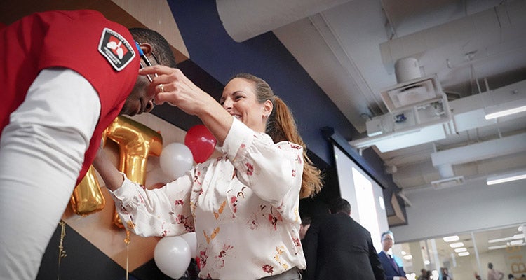 Student receiving stethoscope at a ceremony