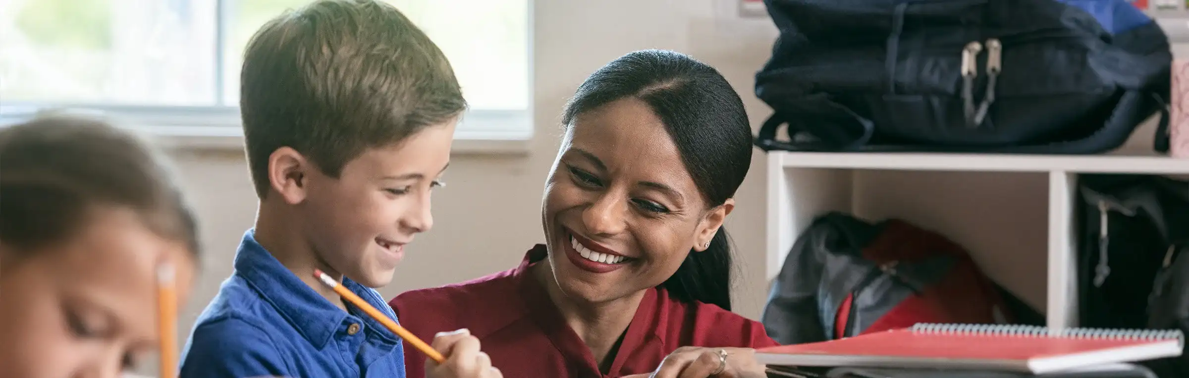 Photo of a teacher and an elementary student.