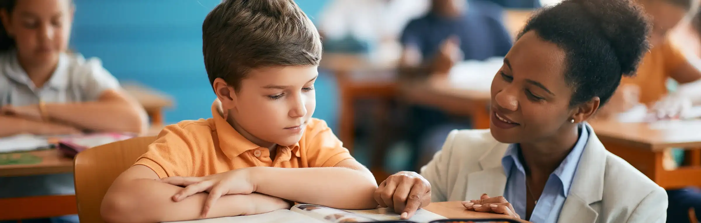 Photo of a teacher engaging with a student.