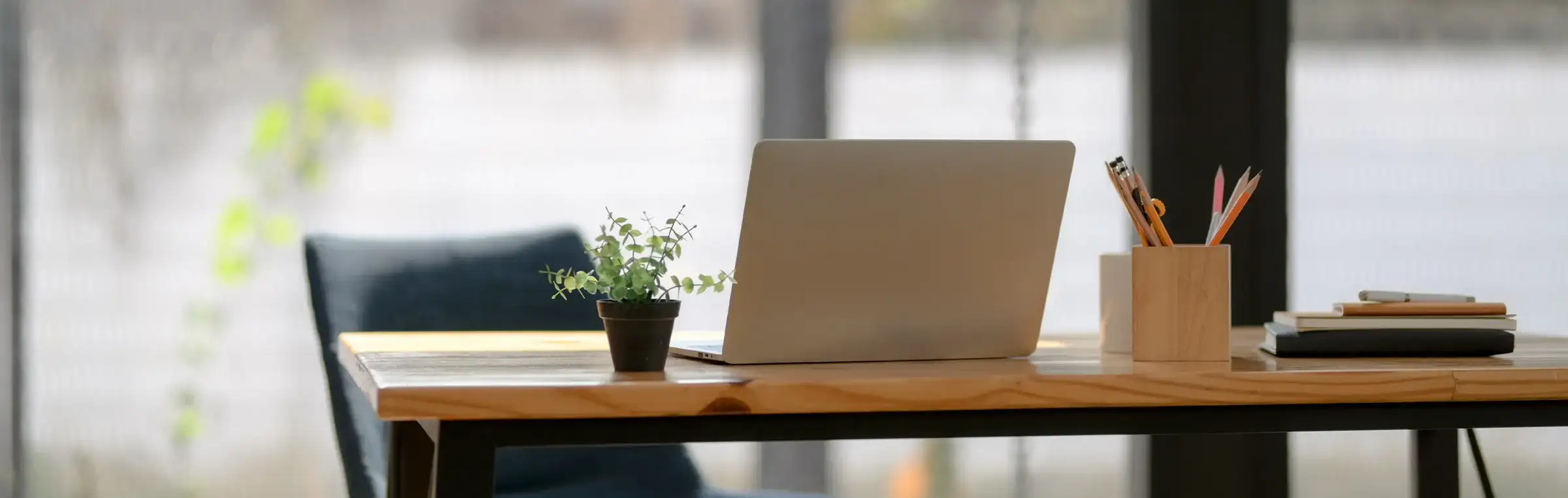 Photo of a desk with a laptop and some decor on it.