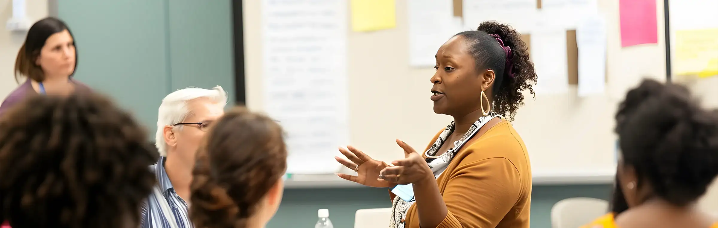 Photo of a teacher engaging with a diverse group.