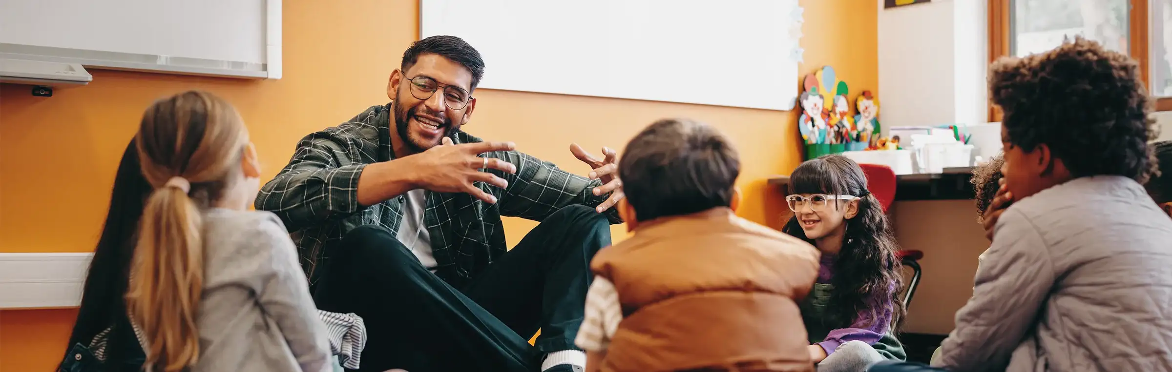 Photo of a teacher engaging with a diverse group of students.